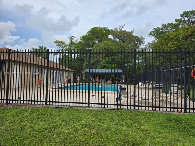 a view of a yard with wooden fence