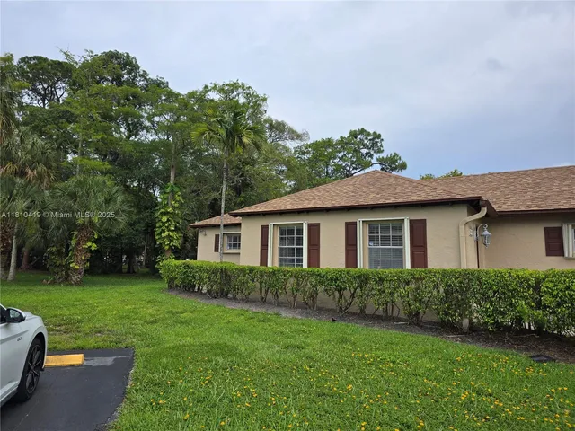 a view of a house with a yard and a garden