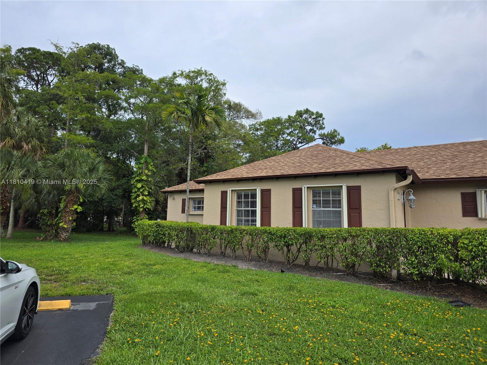 22374 Southwest 57th Circle Boca Raton, FL 33428 - Photo 31 of 31 a view of a house with a yard and a garden