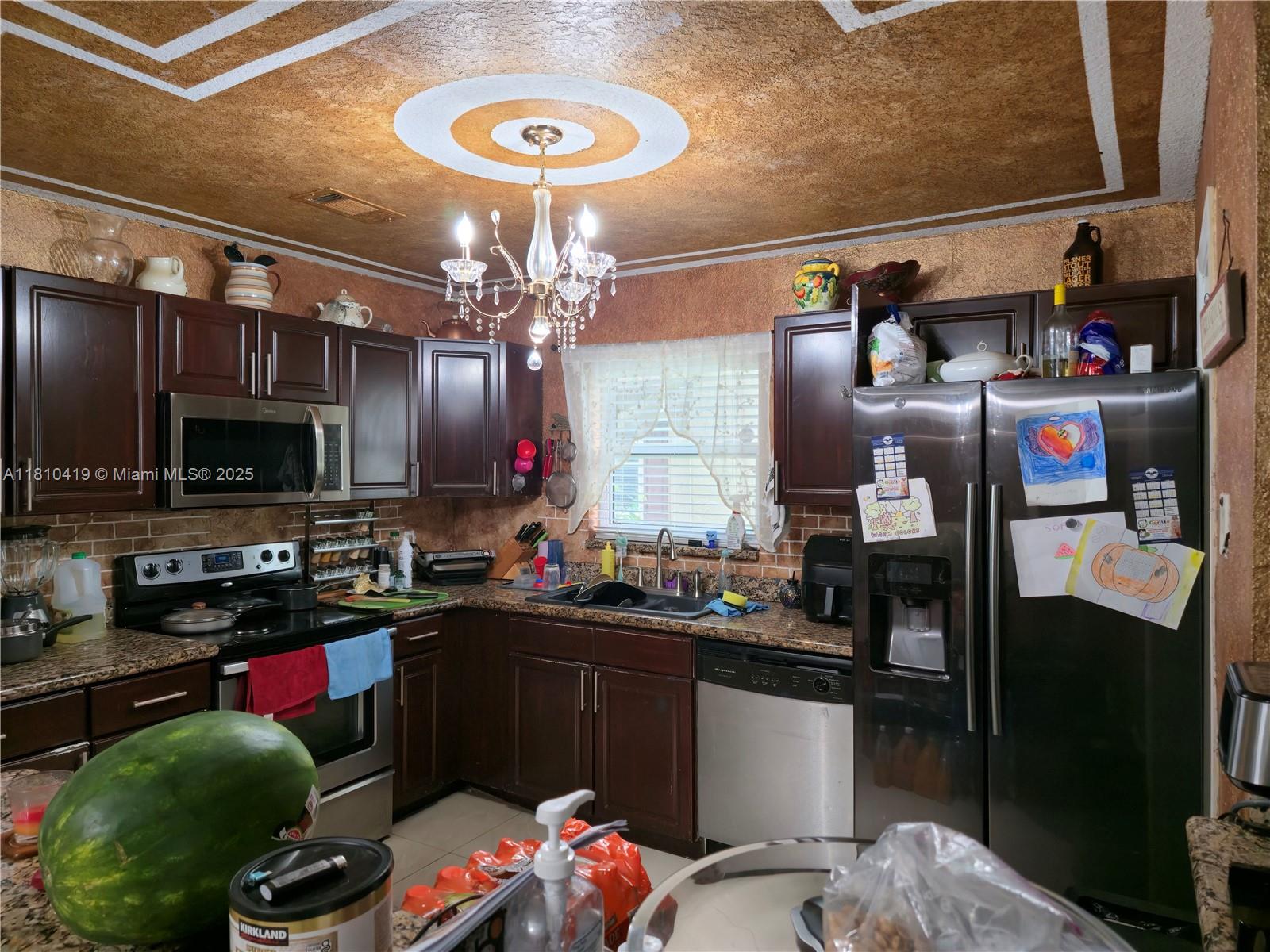 22374 Southwest 57th Circle Boca Raton, FL 33428 - Photo 6 of 31 a kitchen with a sink and cabinets