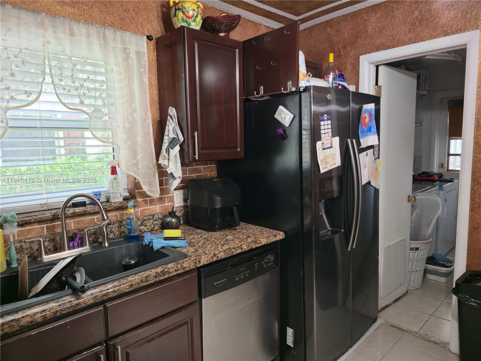 22374 Southwest 57th Circle Boca Raton, FL 33428 - Photo 8 of 31 a kitchen with a refrigerator and a sink