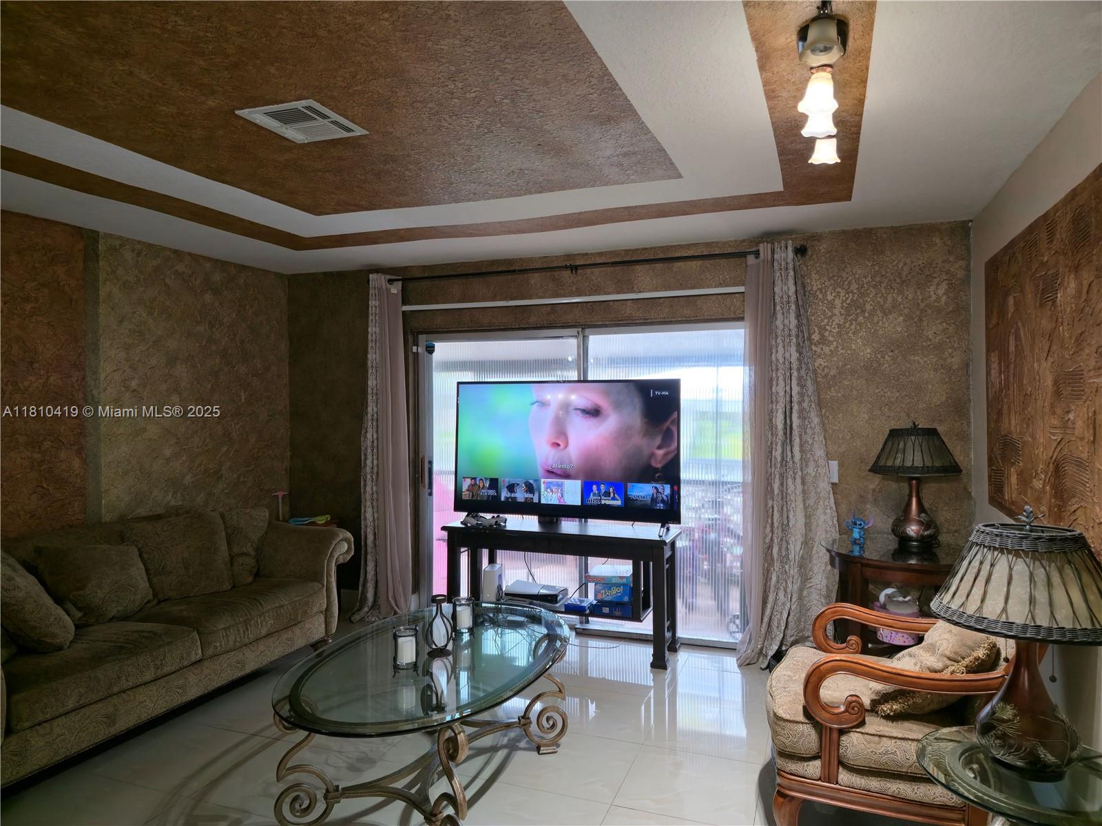 22374 Southwest 57th Circle Boca Raton, FL 33428 - Photo 10 of 31 a living room with furniture and a flat screen tv