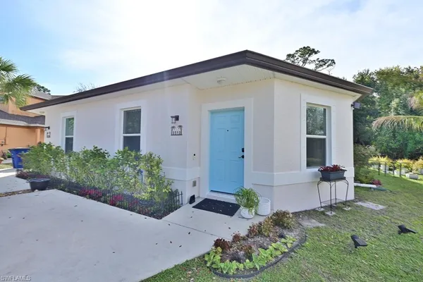 a view of a dining room with furniture and a chandelier