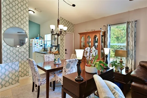 a kitchen with stainless steel appliances a sink a stove a chimney a refrigerator and cabinets