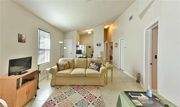 a kitchen with stainless steel appliances a refrigerator sink and white cabinets
