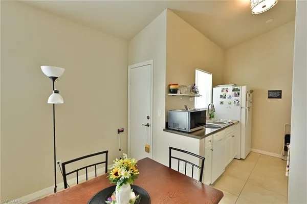 a kitchen with stainless steel appliances cabinets and a window