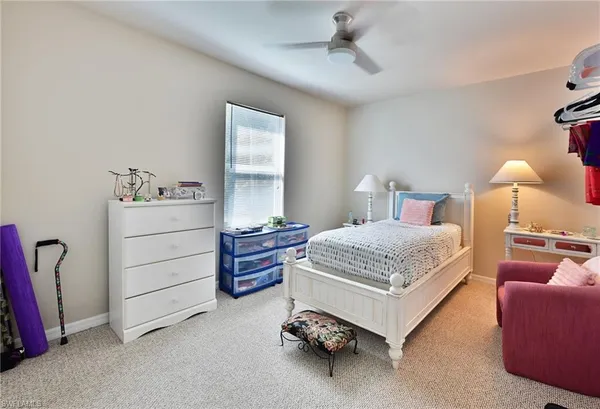 a bed room with a bed and a chair