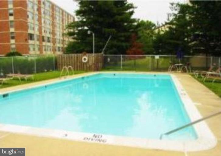 4401 Roland Avenue, Unit 607 Baltimore, MD 21210 - Photo 2 of 16 a view of a swimming pool with a yard