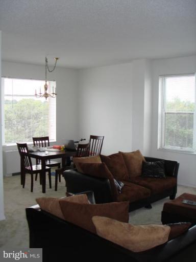 4401 Roland Avenue, Unit 607 Baltimore, MD 21210 - Photo 16 of 16 a living room with furniture and a large window
