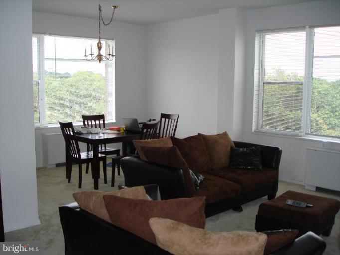 4401 Roland Avenue, Unit 607 Baltimore, MD 21210 - Photo 10 of 16 a living room with furniture wooden floor and a window