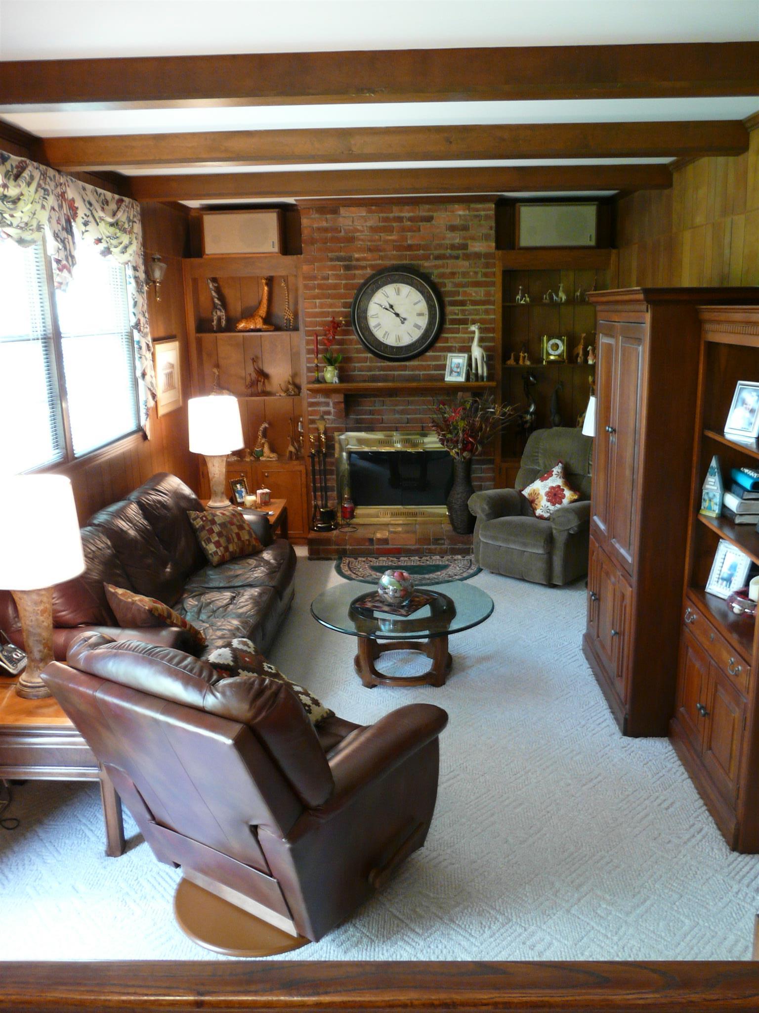 5333 Overton Road Nashville, TN 37220 - Photo 10 of 18 Den offers wood burning fireplace, wood paneling, exposed ceiling beams and berber carpet.