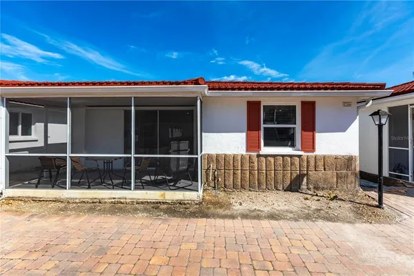 a view of a house with a wooden deck