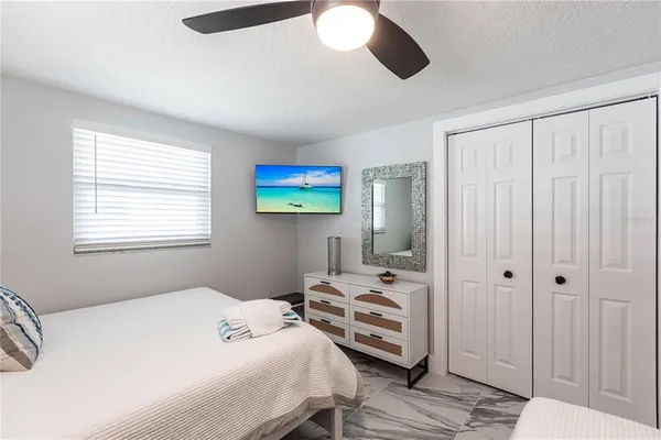 a bedroom with a bed and a chandelier
