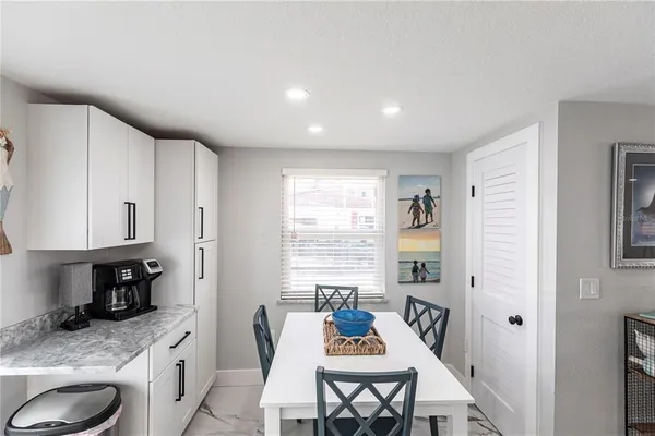 a kitchen with granite countertop a sink stove and cabinets