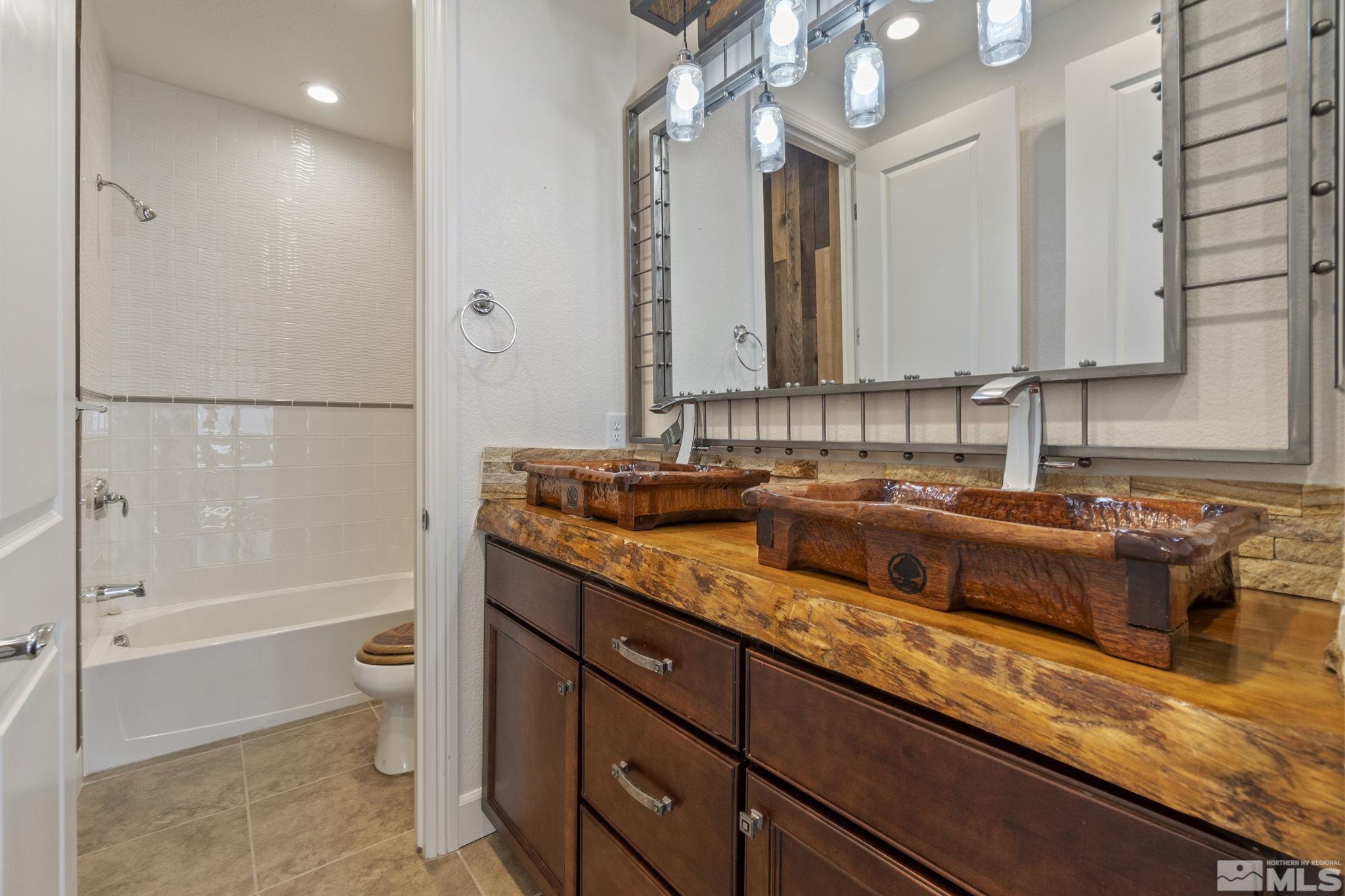2320 Patayan Road Reno, NV 89521 - Photo 31 of 36 a bathroom with a double vanity sink and a mirror
