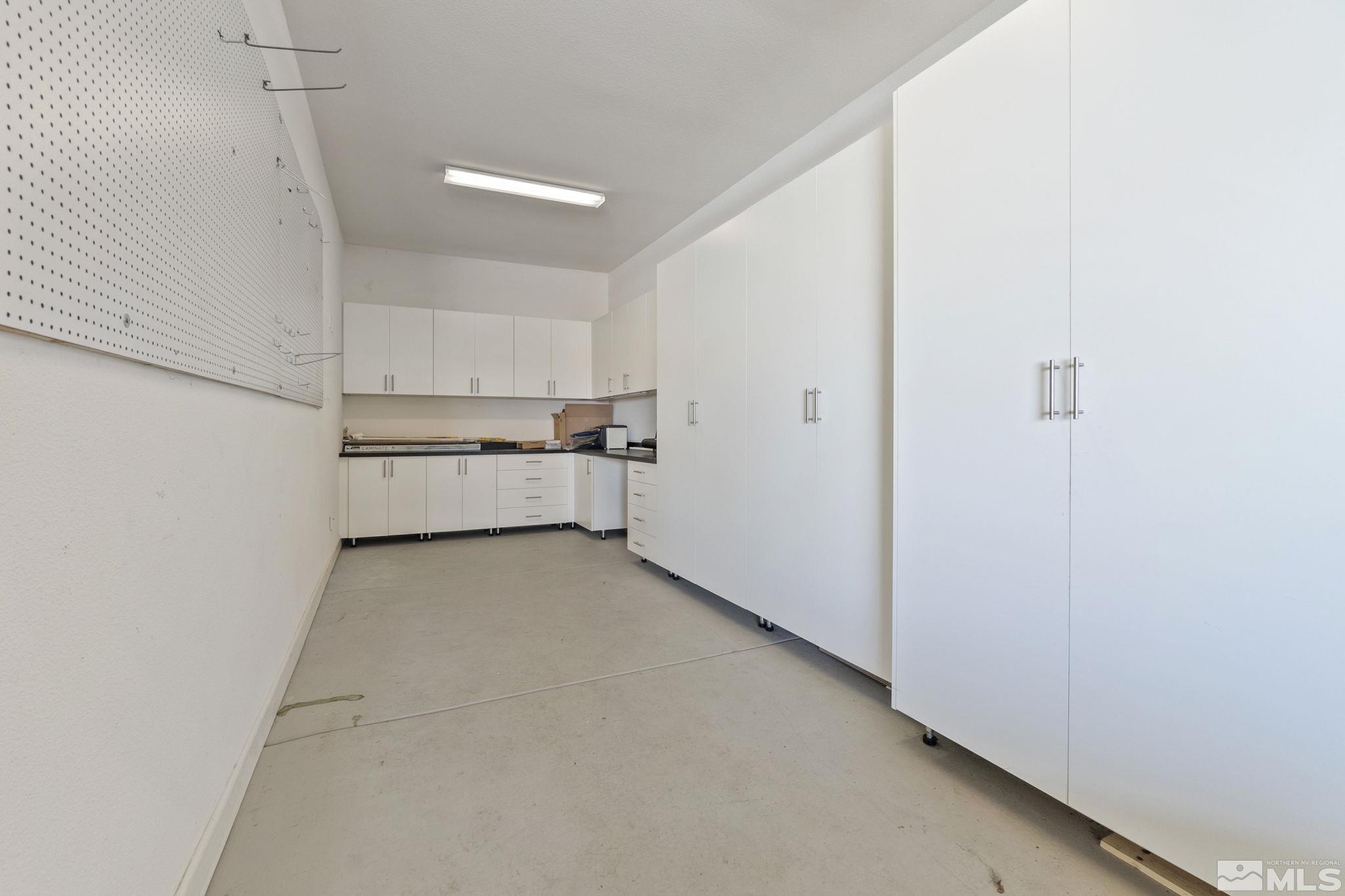 2320 Patayan Road Reno, NV 89521 - Photo 33 of 36 a view of a kitchen with a sink and dishwasher a refrigerator with white cabinets