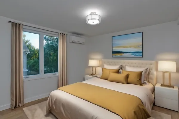 a bedroom with a bed and a painting on the wall