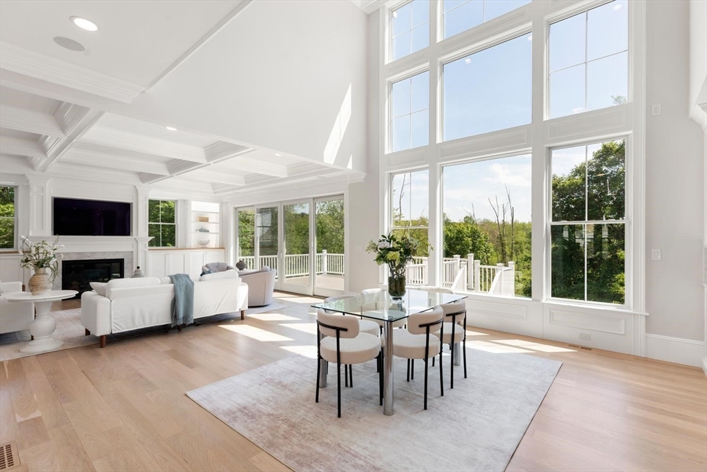320 Concord Avenue Lexington, MA 02421 - Photo 13 of 40 a dining room with wooden floor and large windows