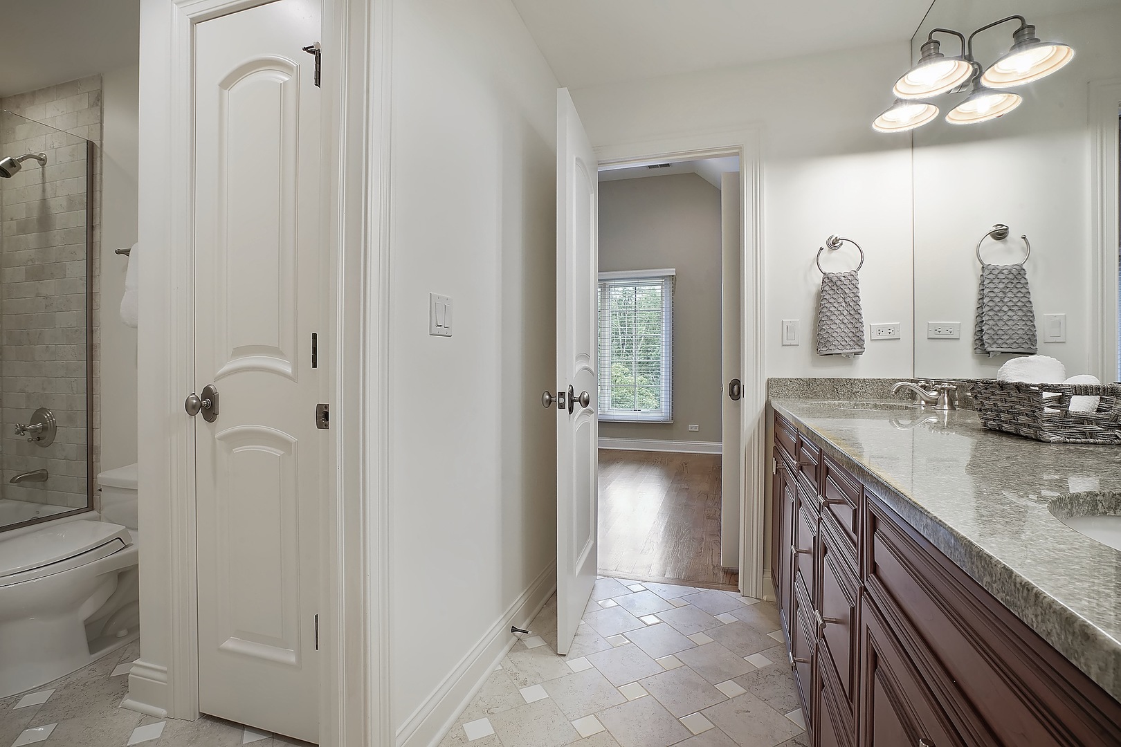 1004 Lee Road Northbrook, IL 60062 - Photo 12 of 30 a bathroom with a granite countertop sink a toilet and shower