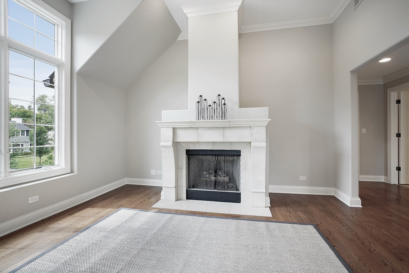1004 Lee Road Northbrook, IL 60062 - Photo 16 of 30 a view of an empty room with wooden floor fireplace and a window