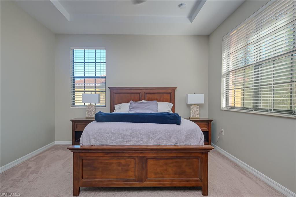 7658 Bristol Circle Naples, FL 34120 - Photo 11 of 32 a bedroom with a bed and a window