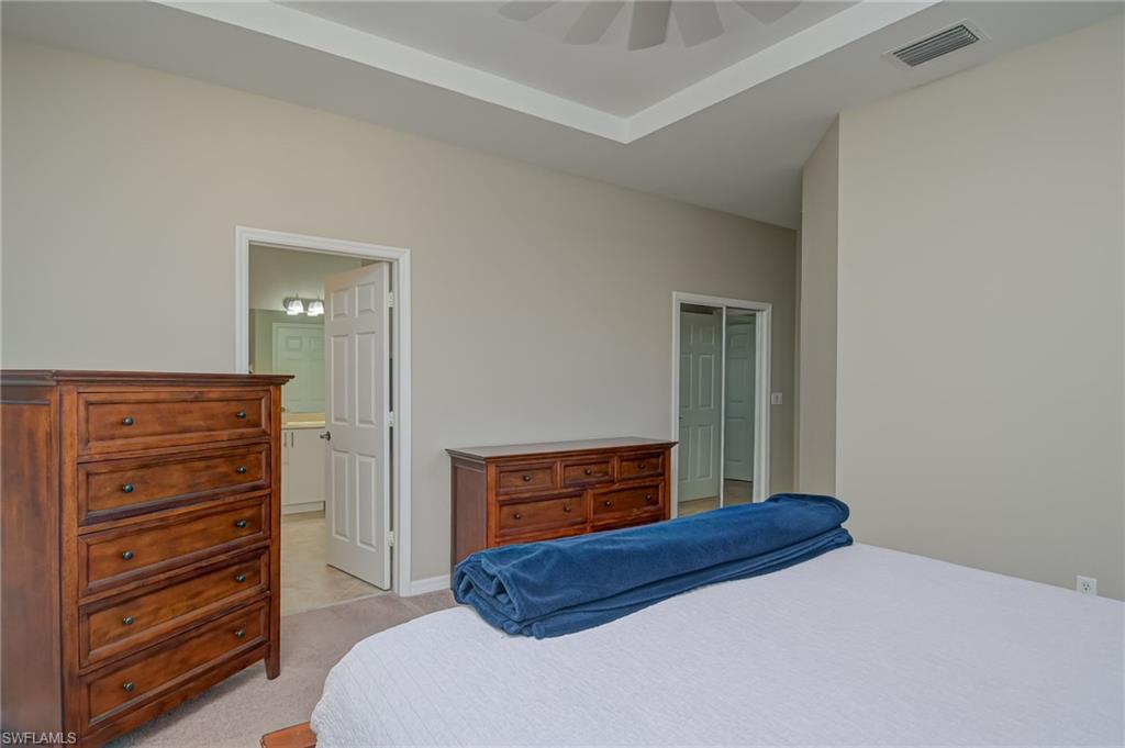 7658 Bristol Circle Naples, FL 34120 - Photo 12 of 32 a bedroom with a bed and a dresser