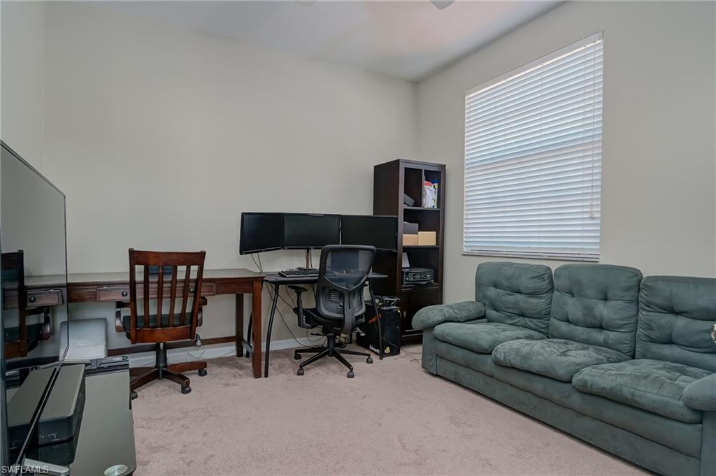 7658 Bristol Circle Naples, FL 34120 - Photo 13 of 32 a livingroom with workspace and a couch
