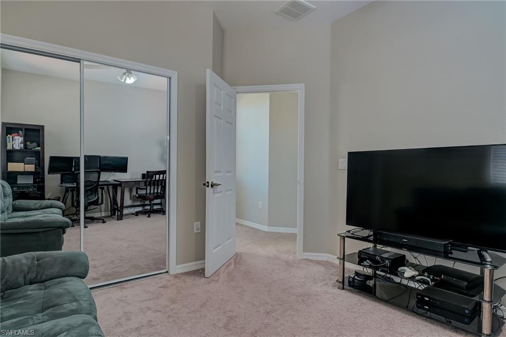 7658 Bristol Circle Naples, FL 34120 - Photo 14 of 32 a living room with furniture and a flat screen tv