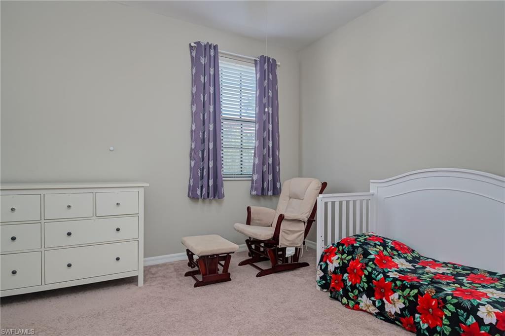 7658 Bristol Circle Naples, FL 34120 - Photo 15 of 32 a bedroom with furniture and a baby crib