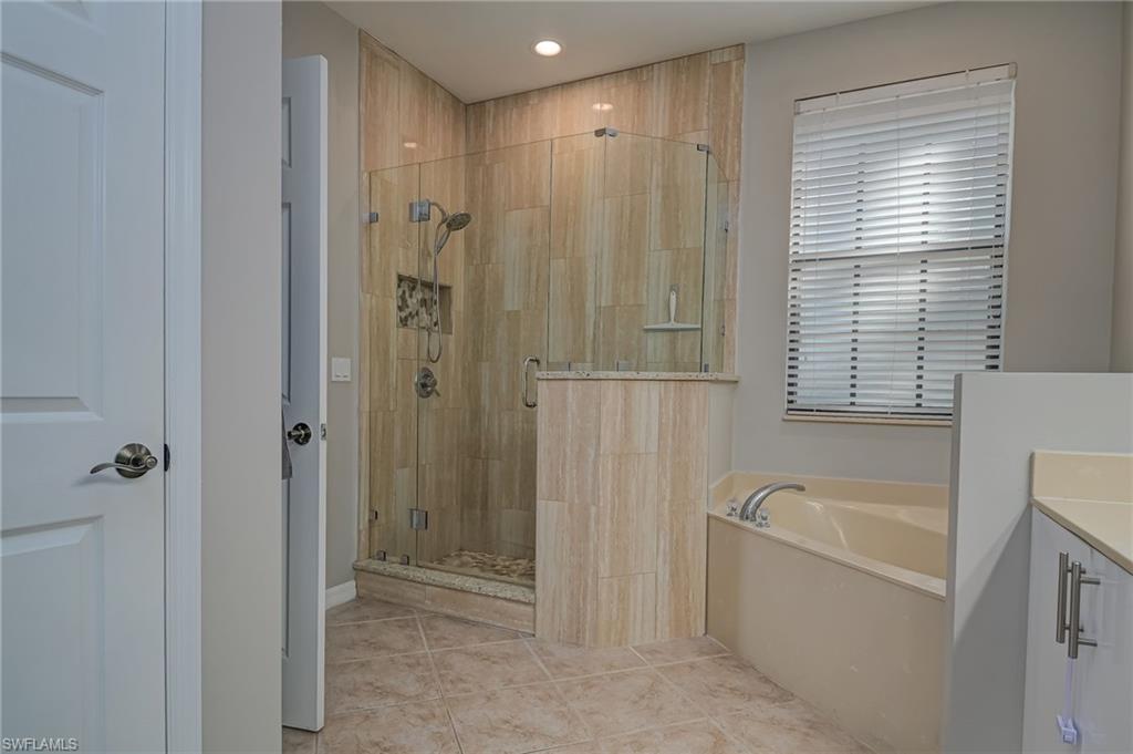 7658 Bristol Circle Naples, FL 34120 - Photo 18 of 32 a bathroom with a bathtub and shower