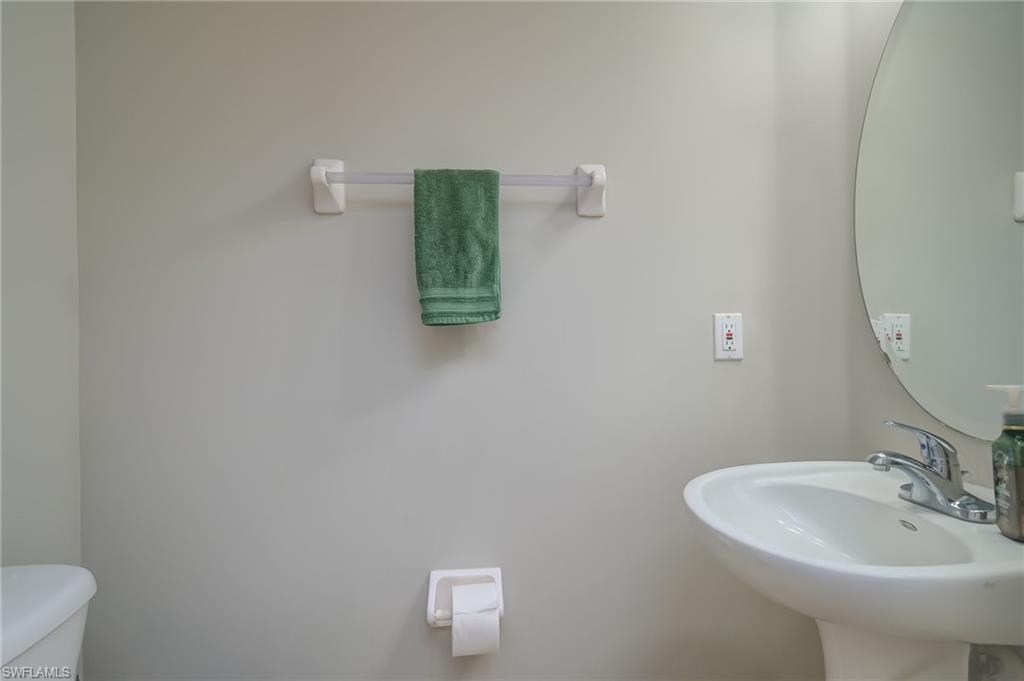 7658 Bristol Circle Naples, FL 34120 - Photo 20 of 32 a bathroom with a sink and a mirror