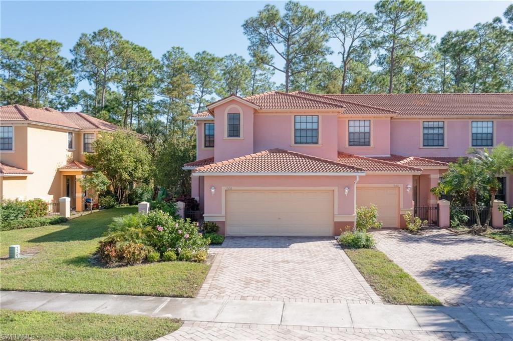 7658 Bristol Circle Naples, FL 34120 - Photo 25 of 32 a view of a white house with a yard and plants