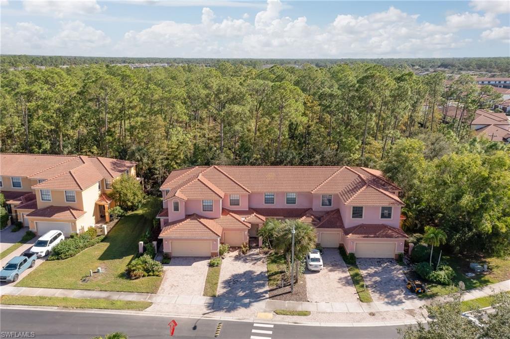 7658 Bristol Circle Naples, FL 34120 - Photo 26 of 32 an aerial view of a house with a garden and lake view