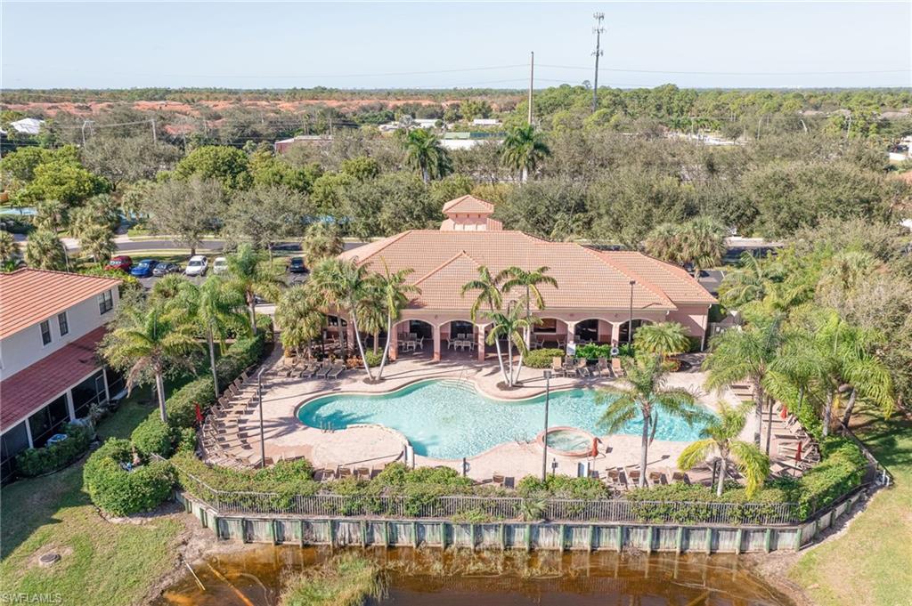 7658 Bristol Circle Naples, FL 34120 - Photo 27 of 32 a view of a swimming pool with a patio