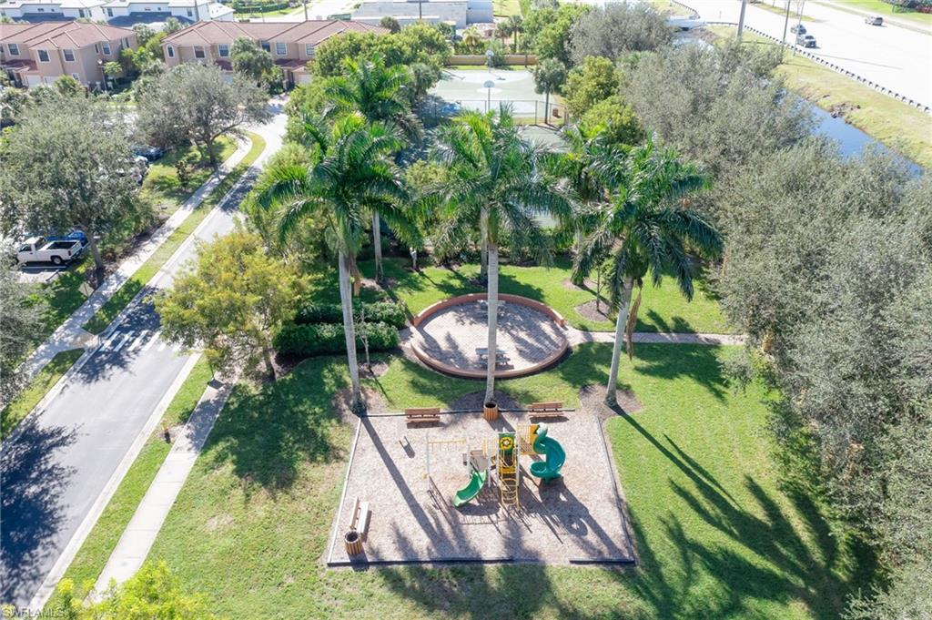 7658 Bristol Circle Naples, FL 34120 - Photo 30 of 32 a view of a backyard with plants and a fountain