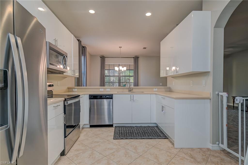 7658 Bristol Circle Naples, FL 34120 - Photo 3 of 32 a kitchen with stainless steel appliances granite countertop a refrigerator and a sink