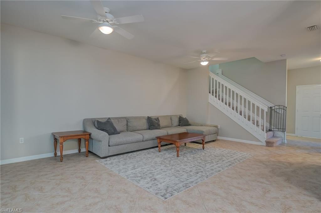 7658 Bristol Circle Naples, FL 34120 - Photo 7 of 32 a living room with furniture and a ceiling fan