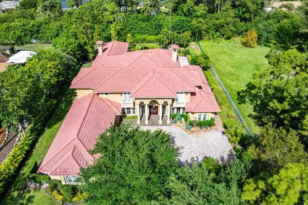 an aerial view of a house with garden space and street view
