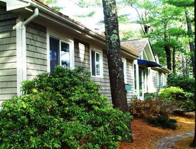 108 Pine Ridge Road Cotuit, MA 02635 - Photo 4 of 18 a front view of a house with garden