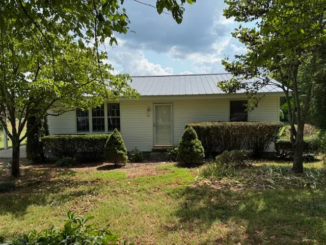 a view of a house with a yard and sitting area
