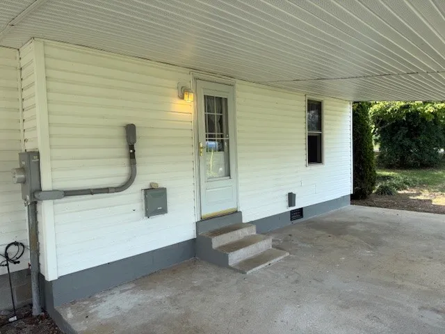 a view of a porch with a table and chairs