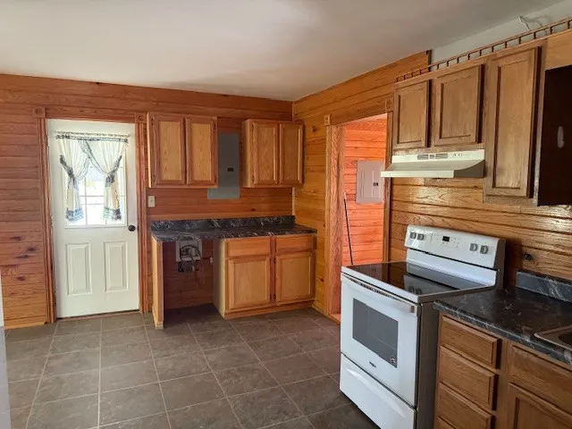 a kitchen that has a stove and cabinets