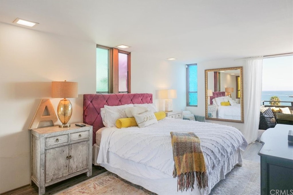 3047 Ocean Boulevard Corona del Mar, CA 92625 - Photo 20 of 53 a bedroom with a bed and wooden floor