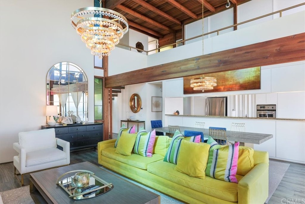 3047 Ocean Boulevard Corona del Mar, CA 92625 - Photo 24 of 53 a living room with furniture and a chandelier