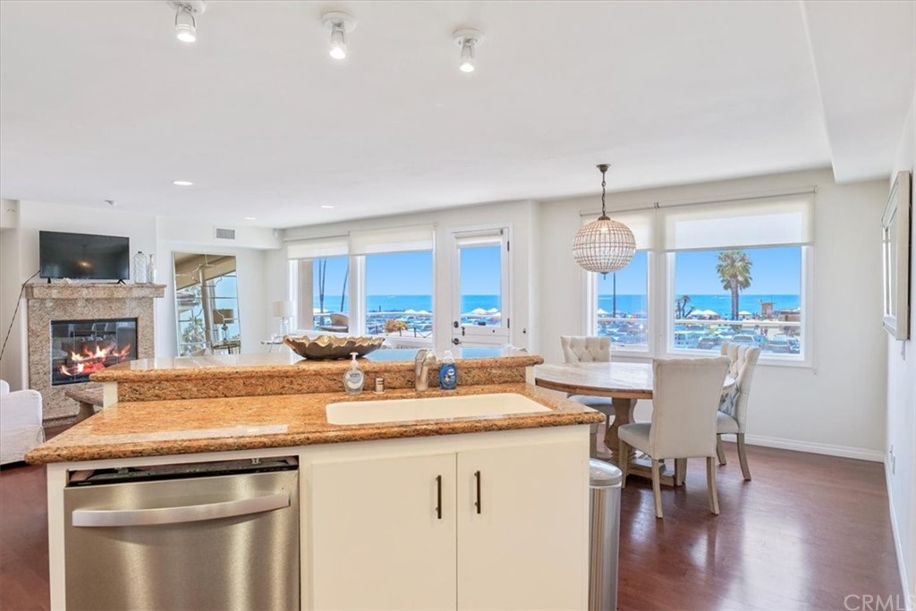 3047 Ocean Boulevard Corona del Mar, CA 92625 - Photo 35 of 53 a kitchen with a table chairs stove and cabinets