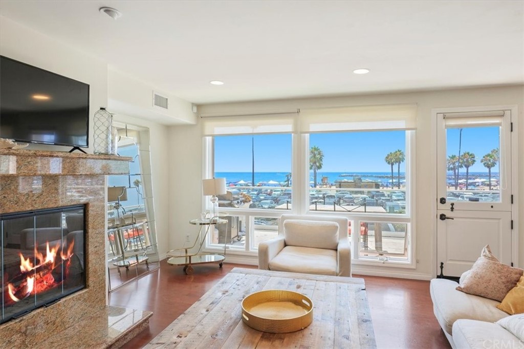 3047 Ocean Boulevard Corona del Mar, CA 92625 - Photo 37 of 53 a living room with furniture a flat screen tv and a fireplace