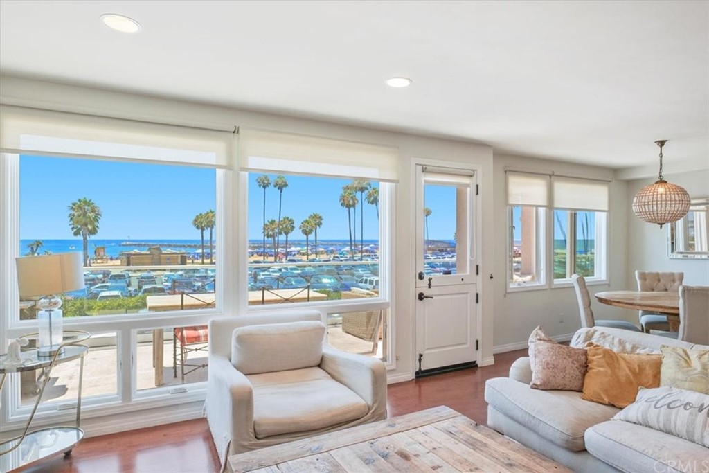 3047 Ocean Boulevard Corona del Mar, CA 92625 - Photo 38 of 53 a living room with furniture and a floor to ceiling window