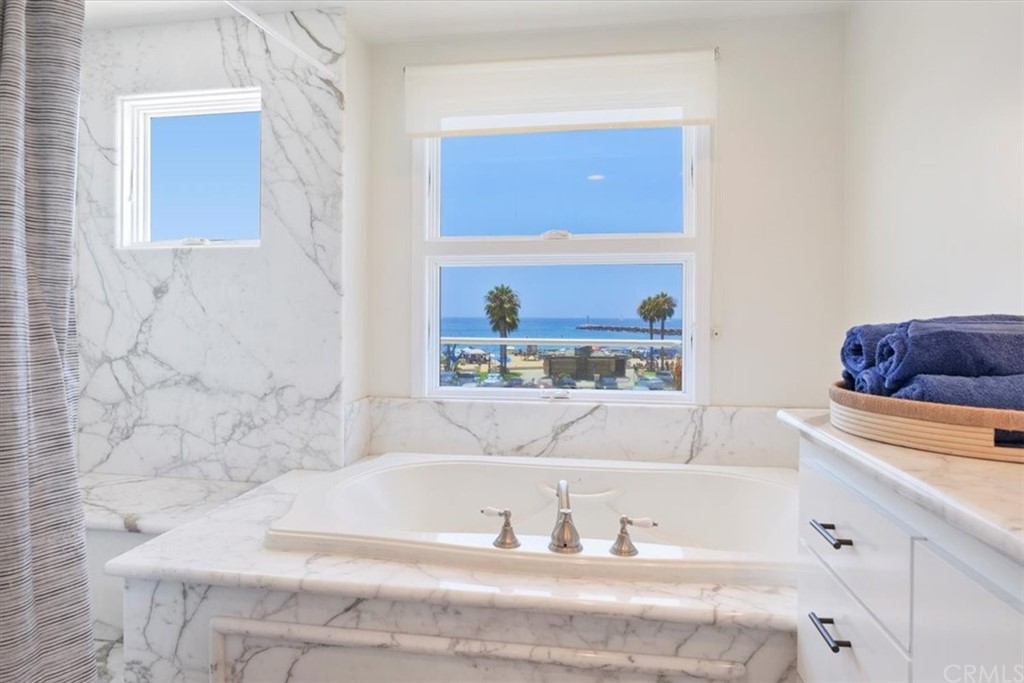 3047 Ocean Boulevard Corona del Mar, CA 92625 - Photo 48 of 53 a bathroom with a bathtub and a window