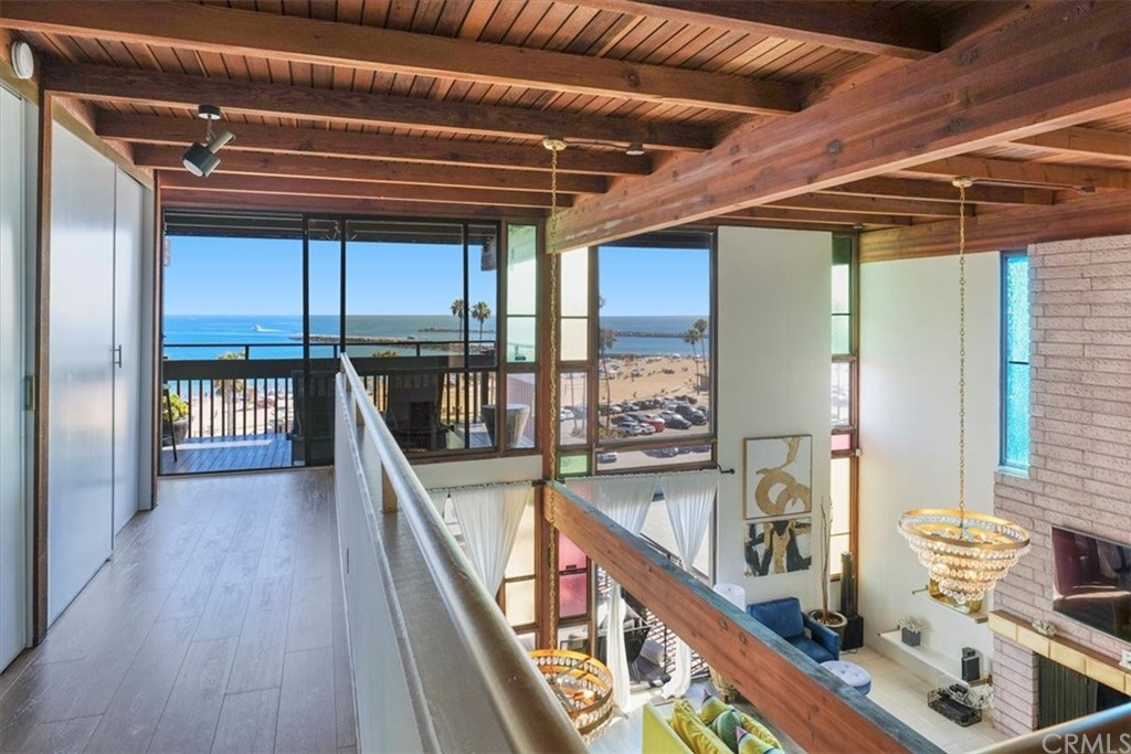 3047 Ocean Boulevard Corona del Mar, CA 92625 - Photo 8 of 53 a view of a hallway with wooden floor and stairs