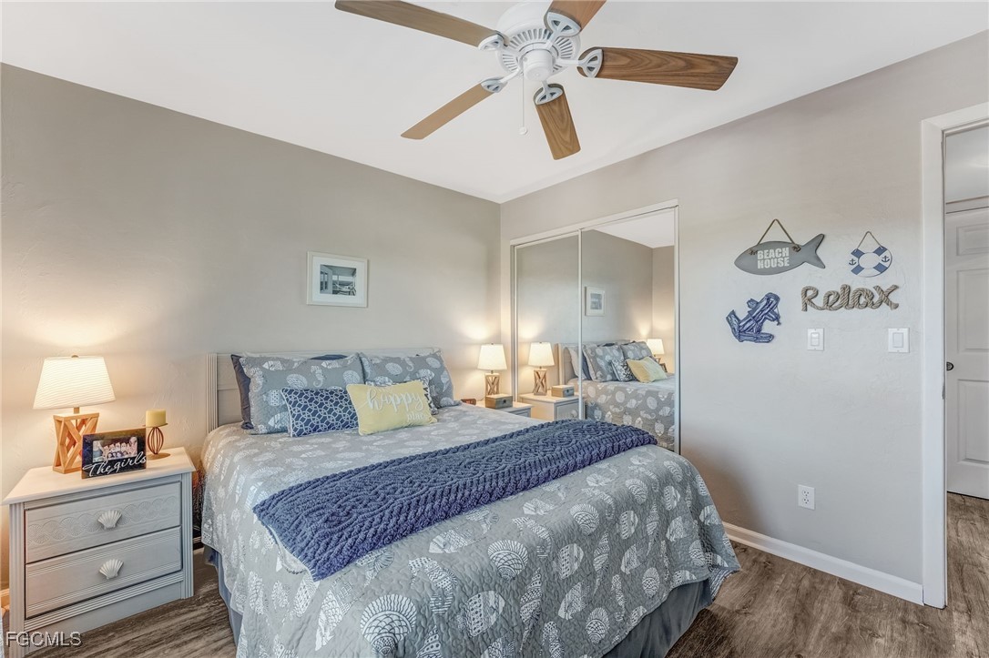 16007 Davis Road, Unit 524 Fort Myers, FL 33908 - Photo 18 of 36 a bedroom with a bed and a chandelier